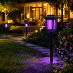Solar mosquito lamp glowing purple in a backyard garden at night
